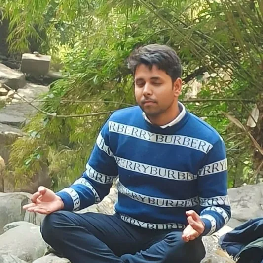 Shanu Quraishi meditating by a stream